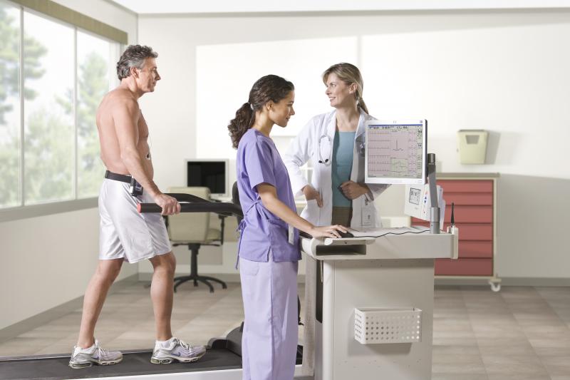 Patient on treadmill exercise stress test with ECG monitoring